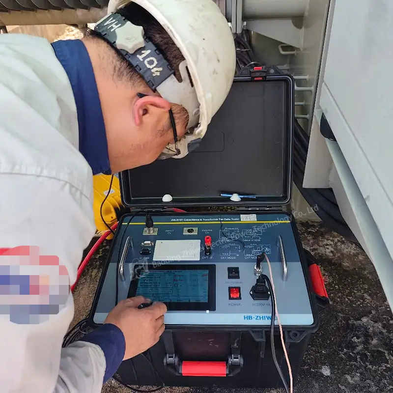 Engineer performing dielectric loss test on substation equipment using the ZWJS101